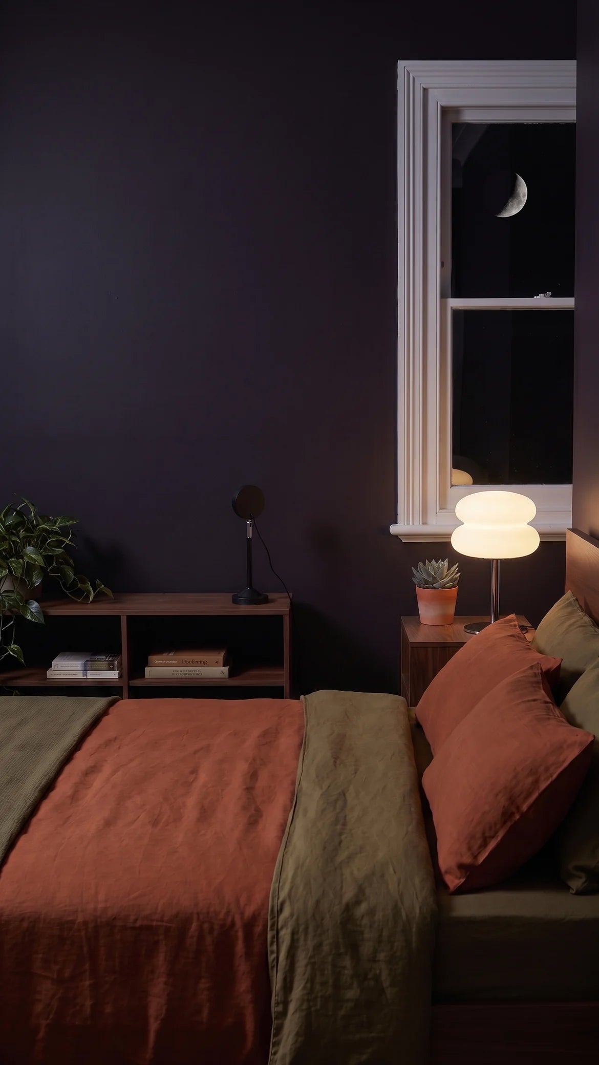 The mushroom lamp glowing warm white on the nightstand