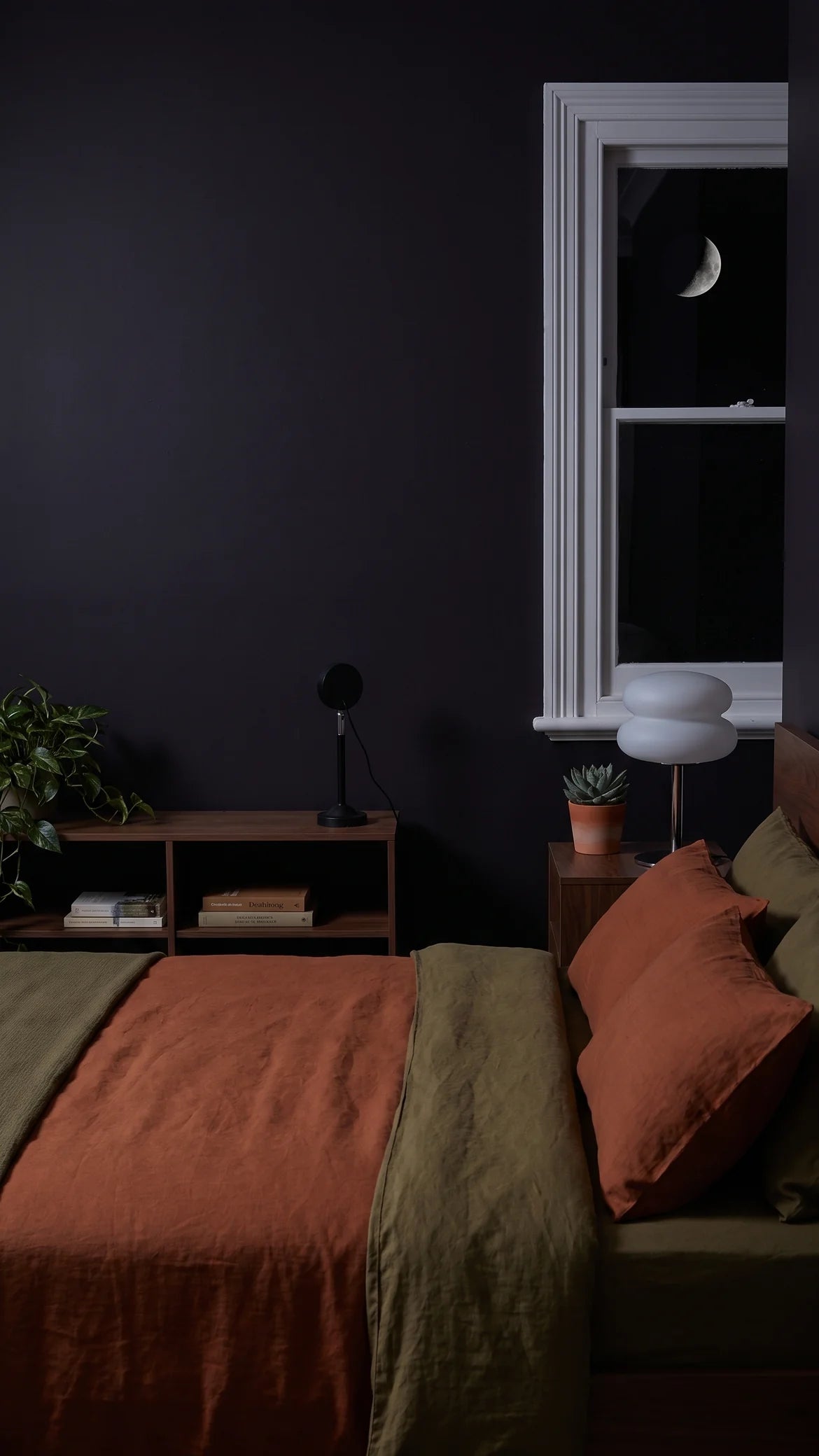 A dark bedroom at night with both lamps switched off